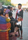 Ranohira, Madagascar - April 29, 2019: Small crowd of unknown Malagasy people standing on the main road in afternoon, one of them