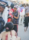 Ranohira, Madagascar - April 29, 2019: Unknown young Malagasy man standing in crowd of other blurred people on busy evening street