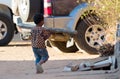 Child playing with a big pole. Many Malagasy children don`t go to school because of