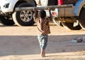 Child playing with a big pole. Many Malagasy children don`t go to school because of