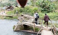 Instable old wooden bridge over a river, roadway for the local people on Ranomafana, Royalty Free Stock Photo