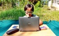 Asian girl study online learning from home with laptop and camera in the front yard