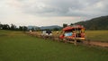 Traditional unique pick up truck for transportation with advertiser in Myanmar language with grass hill background Royalty Free Stock Photo