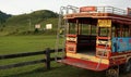 Traditional unique pick up truck for transportation with advertiser in Myanmar language with grass hill background