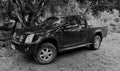 Private Isuzu Dmax, pickup truck 4x4, with parking place in among natural background.