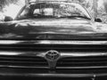 Select focus of the old Hilux Toyota Mighty X, grille private pickup, with century logo background