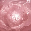 Ranslucent pink crystal with rough, angular surfaces and reflective highlight Royalty Free Stock Photo