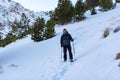 Young Men practicing snowshoes on winter trail in incredible sunny day in winter in the Pyrenees in Andorra