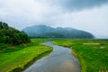 Rantee curve river with mountain fog in cultivated Royalty Free Stock Photo