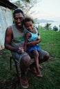 village school teacher Mr. Gibson with his cute daughter in front of their home on a hill above the ocean shore