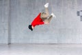 Rap dancer jumping on grey background. Royalty Free Stock Photo