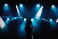 Rap singer with microphone on stage in music hall