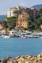 Historic seaside town of Rapallo facing the sea with port. Many boats moored in the marina.