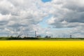 field against industrial backdrop