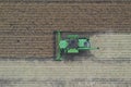 Rape harvest using combine harvester on summer field. Mechanical harvesting of oilseed rape Brassica napus.