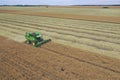 Rape harvest using combine harvester on summer field. Mechanical harvesting of oilseed rape Brassica napus.