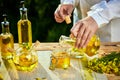 Rapeseed oil bottle in hand of an agronomist or biologist on background rape field Royalty Free Stock Photo