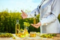 Rapeseed oil bottle in hand of an agronomist or biologist on background rape field Royalty Free Stock Photo