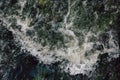 The rapid flow of water with white waves and air bubbles. Top view of a stream of fast flowing water Royalty Free Stock Photo