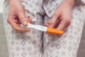 Rapid pregnancy test with negative result in woman`s hand sitting in bathroom