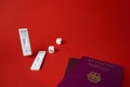 Rapid SARS-Cov-2 Antigen test,negative result,unused,dice on red,pair german tourist passport.Bad or good luck concept