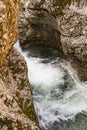 Rapid waterfall stream flowing among rocks in canyon in Austrian alps on autumn day Royalty Free Stock Photo