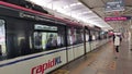 RapidKL LRT train public transport passing through Hang Tuah station. People taking LRT as transportation to work and shopping.