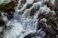 rapids of mountain rivers with fast water and large rocky boulders. Rapid flow of a mountain river in spring, close-up Royalty Free Stock Photo
