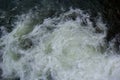 rapids of mountain rivers with fast water and large rocky boulders. Rapid flow of a mountain river in spring, close-up Royalty Free Stock Photo