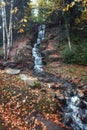 Rapids in the stream run through a beautiful park in autumn colors Royalty Free Stock Photo