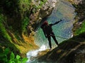 Rappelling on forest waterfall