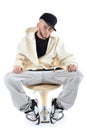 Rapper sits on chair and looks at camera Royalty Free Stock Photo