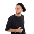 Rapper wearing black t-shirt and hat looks into distance Royalty Free Stock Photo