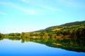 Rapturous view with the lake reflecting greenery, Marche hills and the sky