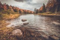 Raquette River surrounded by brilliant fall foliage in Long Lake NY, ADK Mountains Royalty Free Stock Photo