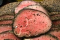 Rare cooked peppered Eye of Round roast beef sliced in a pile Royalty Free Stock Photo