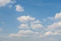 Rare cumulus clouds against a clear blue sky