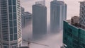 Rare early morning winter fog above the Dubai Marina skyline and skyscrapers rooftops aerial timelapse. Royalty Free Stock Photo