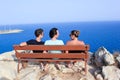 Rare focus of three friends sitting on the bench at the seaside meditarian sea on East of Cyprus, July Royalty Free Stock Photo