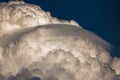 Rare Lenticular cloud Altocumulus lenticularis on top of a cumulus cloud in front of a blue sky Royalty Free Stock Photo