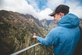 Rare Madeiran chaffinch flies onto a manÃÂ´s hand to get some food crumbs, the man enjoys this once-in-a-lifetime moment with smile