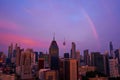 A rare purple sunset with a rainbow on the city after the rain. Cityscape at sunset