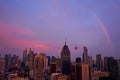 A rare purple sunset with a rainbow on the city after the rain. Cityscape at sunset