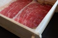 Rare sliced beef with a marbled texture served on a wood box. Premium quality beef Royalty Free Stock Photo