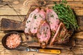 Rare slices of Roast beef sirloin tri tip steak bbq on a wooden cutting board. wooden background. Top view