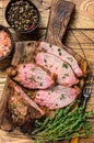 Rare slices of Roast beef sirloin tri tip steak bbq on a wooden cutting board. wooden background. Top view Royalty Free Stock Photo