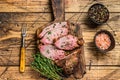 Rare slices of Roast beef sirloin tri tip steak bbq on a wooden cutting board. wooden background. Top view Royalty Free Stock Photo