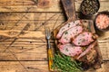 Rare slices of Roast beef sirloin tri tip steak bbq on a wooden cutting board. wooden background. Top view. Copy space Royalty Free Stock Photo