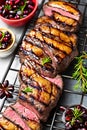 Rare steak being cooked on an iron grill, flam broiled