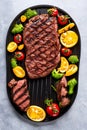 Rare steak being cooked on an iron grill, flam broiled